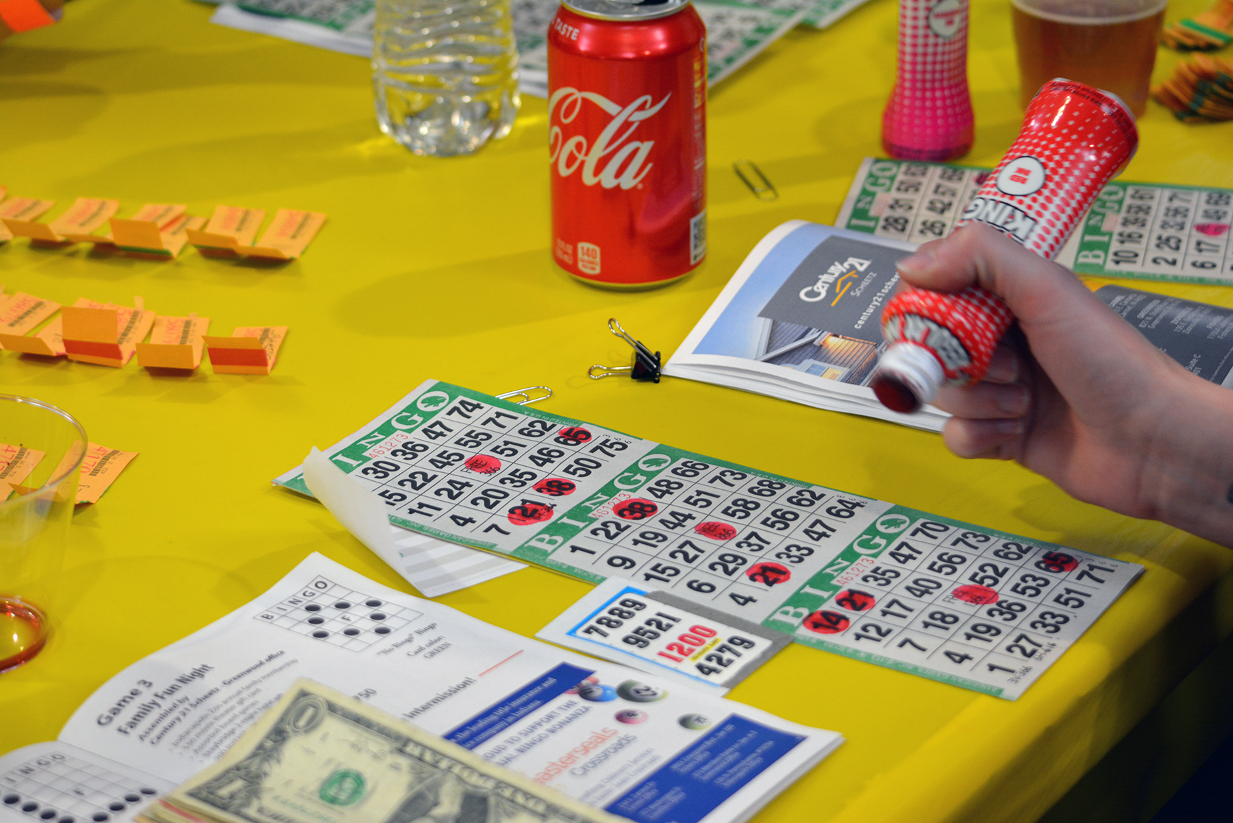 image of bingo player with dauber, game board and program book